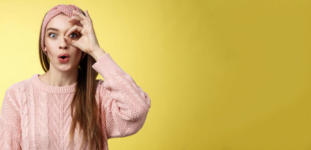 Girl looking through circle from hand amazed, excited folding lips amused and thrilled of awesome...