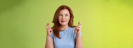 Hopeful enthusiastic ginger middle-aged redhead female praying believe dream come true awaiting...