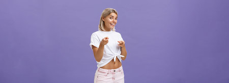 We need you in team. Joyful friendly and good-looking blonde female student in white t-shirt and...