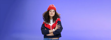 Girl will show winter who boss. Confident and stylish self-assured attractive woman with curly hair...