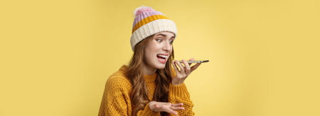 Close-up annoyed angry young woman shouting phone recording audio message irritated arguing having...