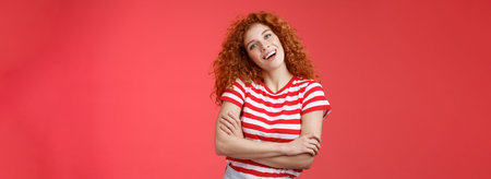 Cheerful carefree redhead playful relaxed curly girl tilt head smiling happy cross arms chest wanna...