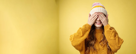 Close-up studio shot charming cute young girl waiting surprise press palms eyes smiling anticipating...