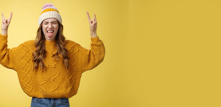 Awesome party rocks. Portrait amused carefree good-looking stylish girl having fun dancing dance floor heavy metal concert show rock-n-roll gesture show tongue rebellious close eyes enjoying musicの写真素材