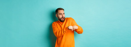 Happy young man do champion dance, celebrating victory or success, light blue background