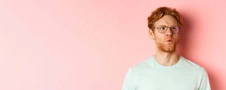 Ouch thats bad. Face of redhead man showing pity and feeling sorry for someone, frowning and looking...