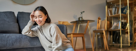 Vertical shot of beautiful asian woman, student sitting at home and studying remotely, elearning...