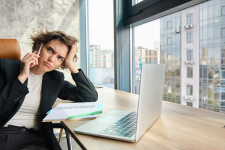 Portrait of serious woman having negotiation over the phone. Businesswoman with smartphone, looking...
