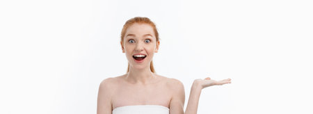 Beauty skin and spa woman wrapped in towel showing copyspace with hand present on side. Isolated on whiteの写真素材