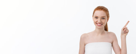 Beauty Skin care portrait of young woman showing copy space by hand.の写真素材