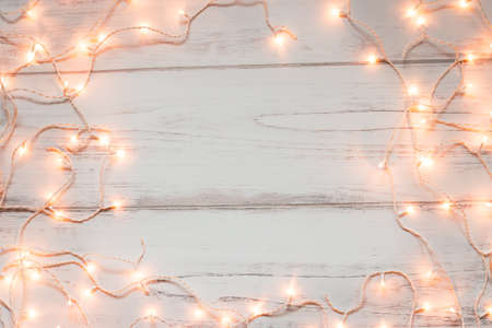 Christmas lights wooden background with space for textの写真素材