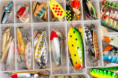 Colorful fishing lures and accessories in the box backgroundの写真素材
