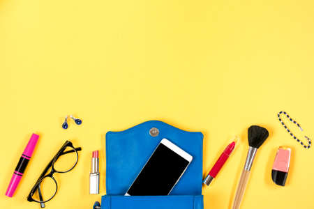Feminine stuff on bright yellow background, top view, copy spaceの写真素材