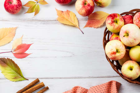 Autumn fall flat lay composition with ripe red apples, yellow leaves, cinnamon.の写真素材