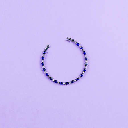 Silver bracelet with blue sapphire stone on pastel backgroundの写真素材