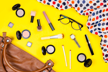 Handbag, make up products, jewelry and accessories. Stylish woman bag stuff flat lay
