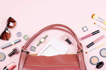 Woman beauty accessories and make up products flat lay on a pastel pink background. Copy spaceの写真素材