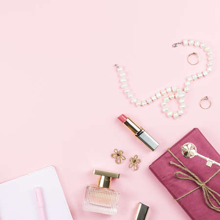 Beauty blog concept. Accessories, flowers, cosmetics and jewelry on pink background, copyspace. Womens Day conceptの写真素材