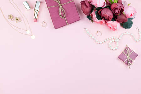 Beauty blog concept. Woman fashion accessories, flowers, cosmetics and jewelry on pink background. Womens Day conceptの写真素材