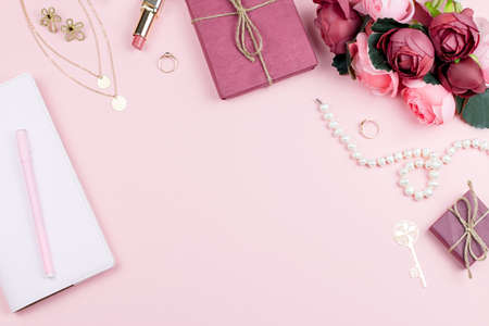 Woman fashion accessories, flowers, cosmetics and jewelry on pink background, copyspace.の写真素材