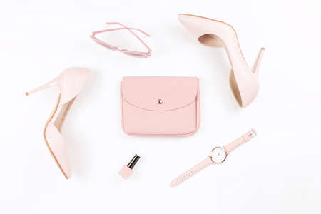 Pale pink female shoes and fashion accessories on white background. Fashion blogger concept flat lay.の写真素材