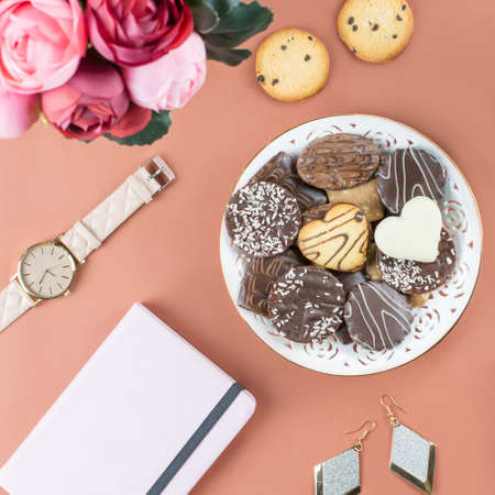 Flat lay home office desk. Feminine workspace with diary, flowers, sweets, fashion accessories. Fashion blogger concept.の写真素材