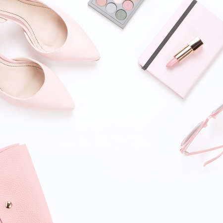 Fashion blogger workspace flat lay with pumps, cosmetics, purse, planner book on pastel background.の写真素材