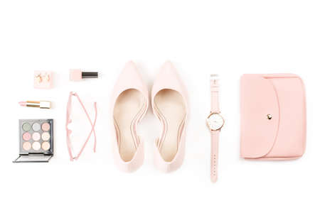 Fashion blogger workspace flat lay with pumps, cosmetics, purse, planner book and flowers.の写真素材