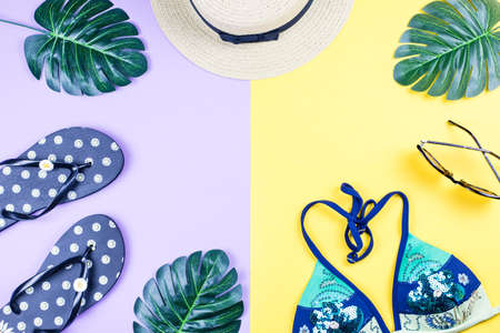Summer holiday background. Tropical summer concept with fashion accessories, bikini, leaves on bright background.の写真素材