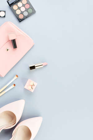 Fashion blogger workspace flat lay with pumps, cosmetics, purse, planner book and flowers.の写真素材