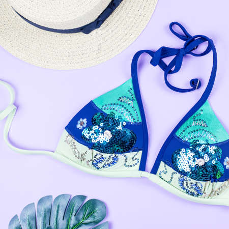 Summer holiday background. Tropical summer concept with fashion accessories, bikini, leaves on bright background.の写真素材
