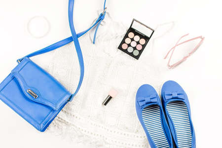 Female summer fashion accessories flat lay with flats, purse, knit top, sunglasses and cosmeticsの写真素材