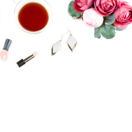 Flat lay home office desk. Feminine workspace with diary, flowers, sweets, fashion accessories. Fashion blogger concept.の写真素材