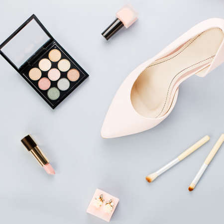 Fashion blogger workspace flat lay with pumps, cosmetics, purse, planner book.の写真素材