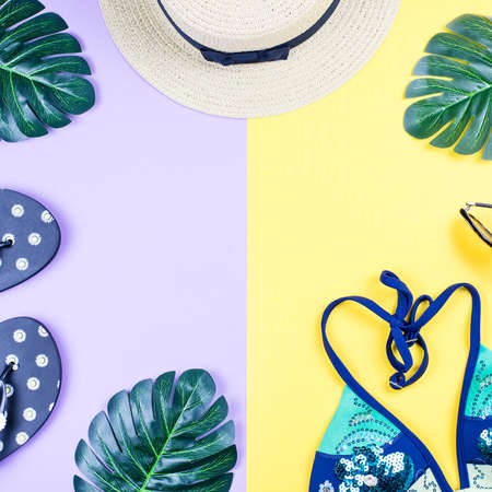 Summer holiday background. Tropical summer concept with fashion accessories, bikini, leaves on bright background.の写真素材