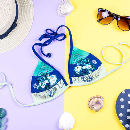 Summer holiday background. Tropical summer concept with fashion accessories, bikini, leaves on bright background.の写真素材