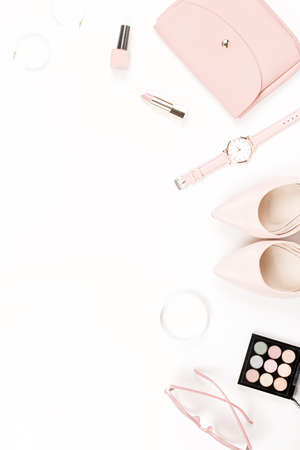 Fashion blogger workspace flat lay with pumps, cosmetics, purse, planner book and flowers.の写真素材