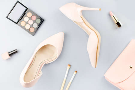Fashion blogger workspace flat lay with pumps, cosmetics, purse, planner book.の写真素材
