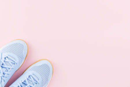 Violet female sneakers on pink background. Flat lay, minimal background.の写真素材