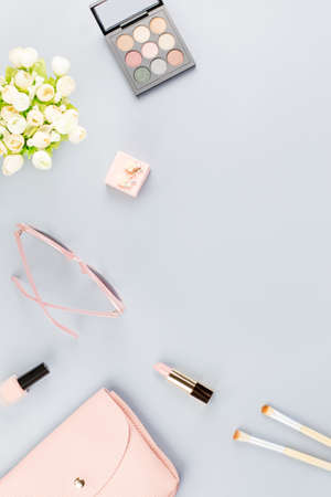 Fashion blogger workspace flat lay with cosmetics, purse, planner book and flowers.の写真素材