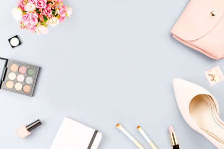Fashion blogger workspace flat lay with pumps, cosmetics, purse, planner book and flowers.の写真素材