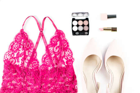 Woman red lace lingerie, pumps and cosmetics on white background.の写真素材
