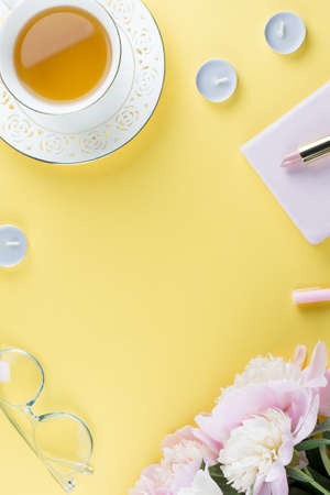 Flat lay home office desk. Feminine workspace with diary, peony flowers, cosmetics, green tea. Fashion blogger concept. Top viewの写真素材