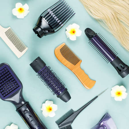 Hairdressing tools and hair extensions on blue wooden background. Top viewの写真素材