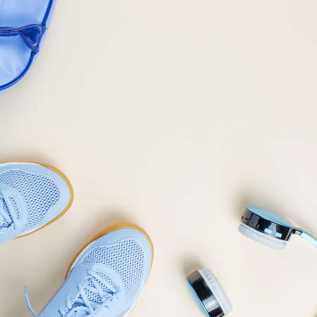 Woman sneakers, headphones, sport bag on pastel background. Sport fashion concept. Flat layの写真素材