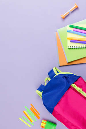 School concept flat lay. Kid backpack, notebook, markers on wooden desktopの写真素材