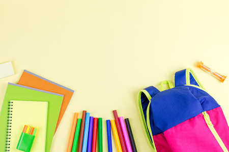 School concept flat lay. Kid backpack, notebook, markers on wooden desktopの写真素材