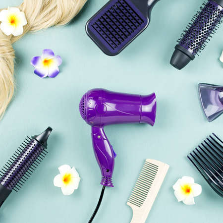 Hairdressing tools and hair extensions on blue wooden background. Top viewの写真素材