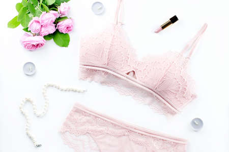 Woman elegant pink lace bra and panties, flowers, jewelry. Stylish lingerie flat lay. Underwear fashion conceptの写真素材