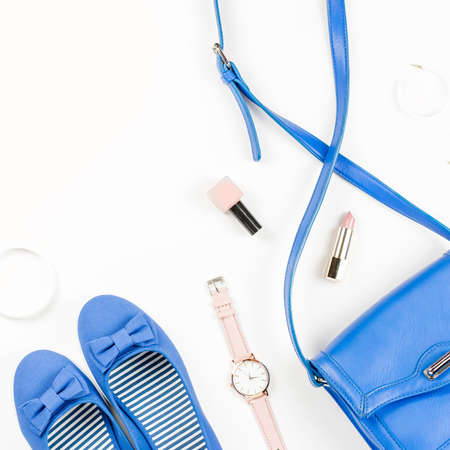 Fashion blogger workspace flat lay with navy flats, cosmetics, purse, sunglasses.の写真素材